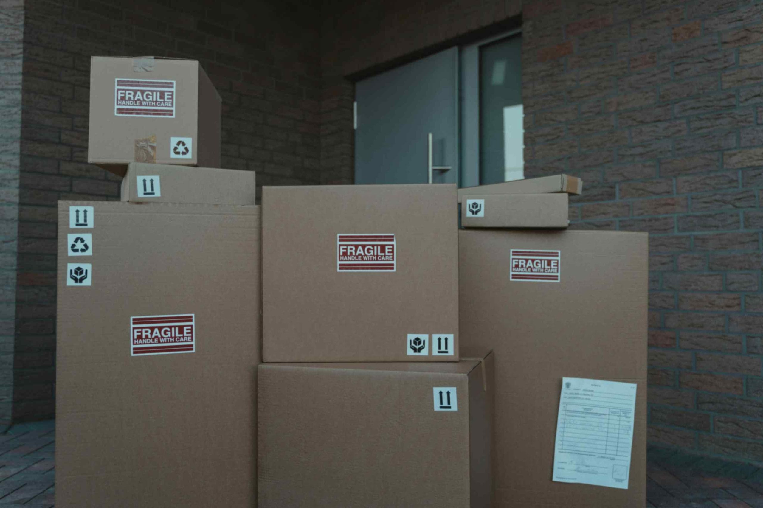 Parcel with shipping label being handled in a warehouse