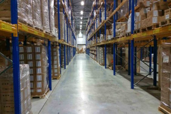 Arranging boxes in a warehouse with shelves of inventory